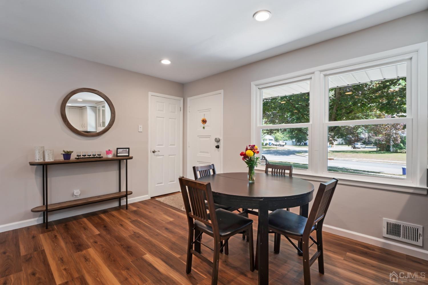 296 Colfax Road North Brunswick, NJ 08902 - Photo 14 of 37 a dining room with a wooden table and chairs