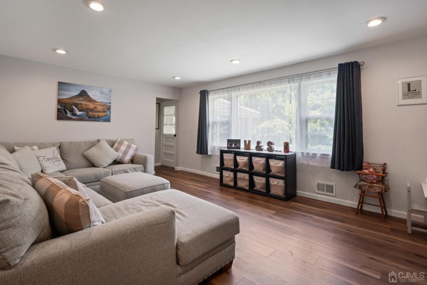 296 Colfax Road North Brunswick, NJ 08902 - Photo 16 of 37 a living room with furniture and a flat screen tv