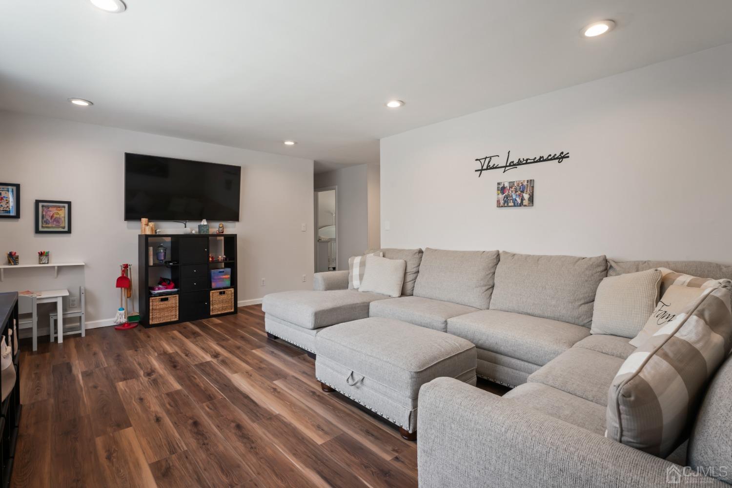 296 Colfax Road North Brunswick, NJ 08902 - Photo 17 of 37 a living room with furniture and a flat screen tv