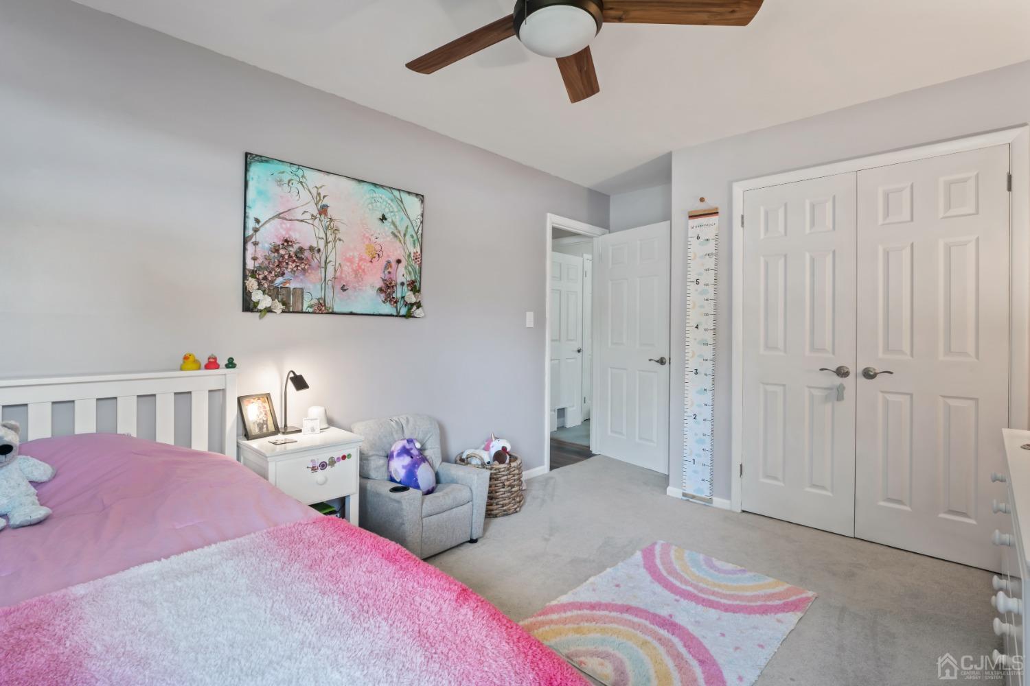 296 Colfax Road North Brunswick, NJ 08902 - Photo 26 of 37 a bedroom with furniture and a chandelier