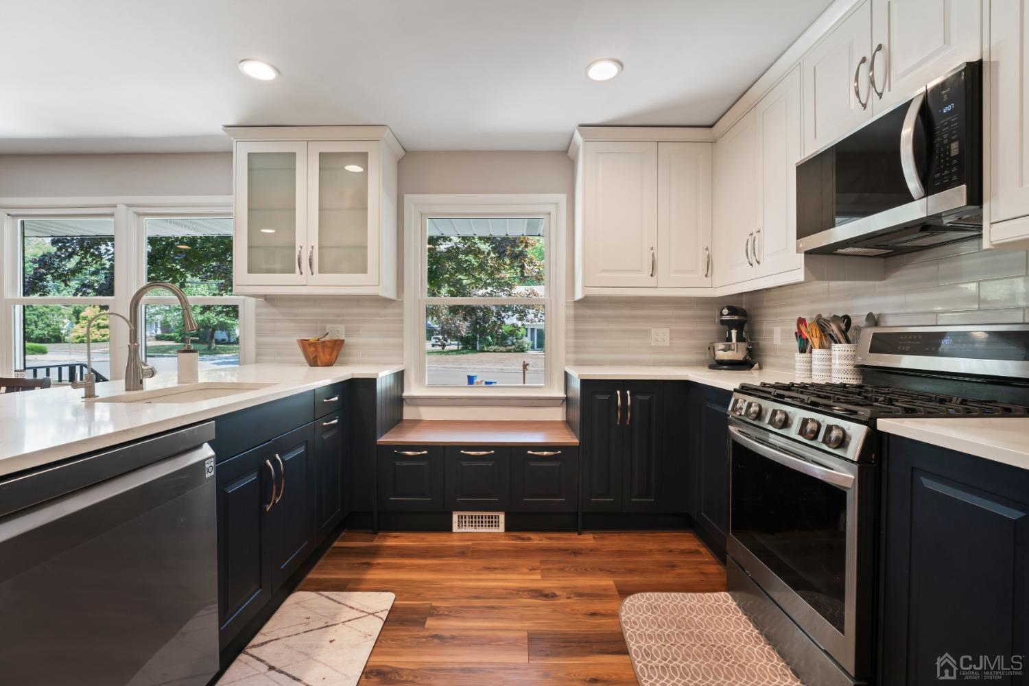 296 Colfax Road North Brunswick, NJ 08902 - Photo 9 of 37 a kitchen with stainless steel appliances granite countertop a stove sink microwave and window