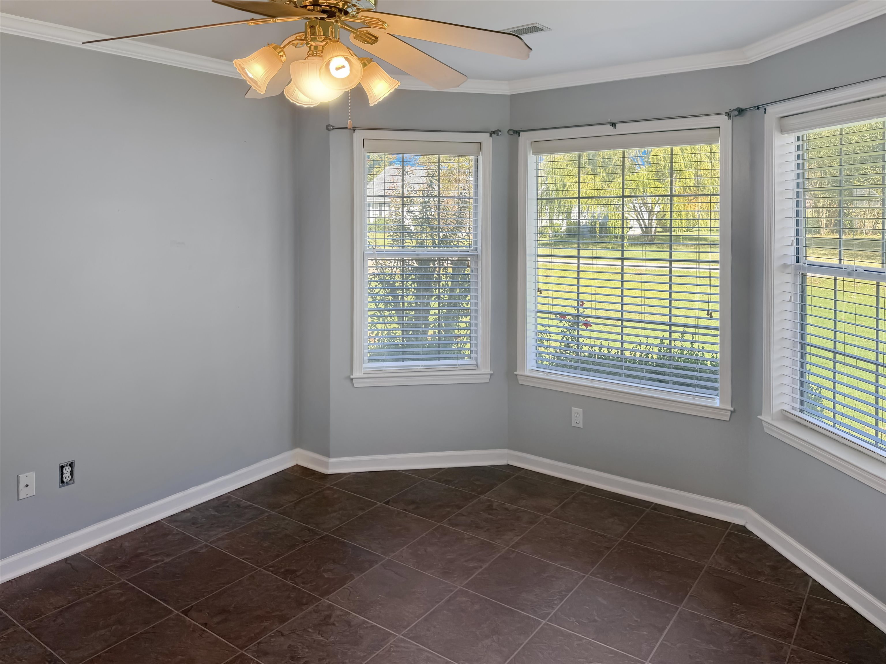 45 Village Avenue Ripley, TN 38063 - Photo 8 of 11 Empty room with ornamental molding, ceiling fan, and dark tile patterned floors