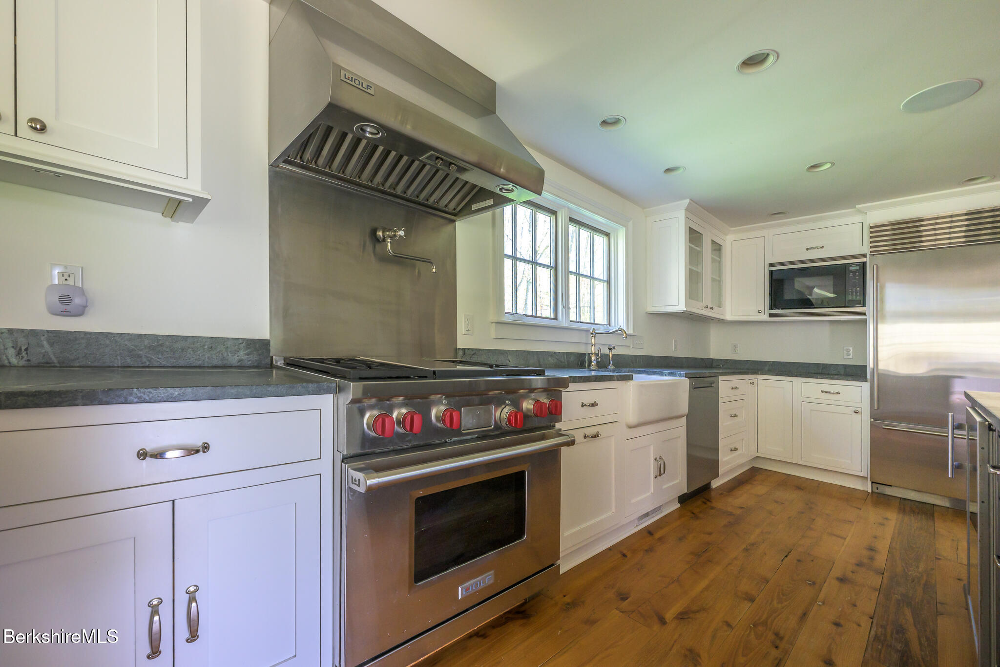 304 Hickey Hill Road Sheffield, MA 01257 - Photo 18 of 60 a kitchen with granite countertop a stove a sink and dishwasher wooden cabinets with granite countertops