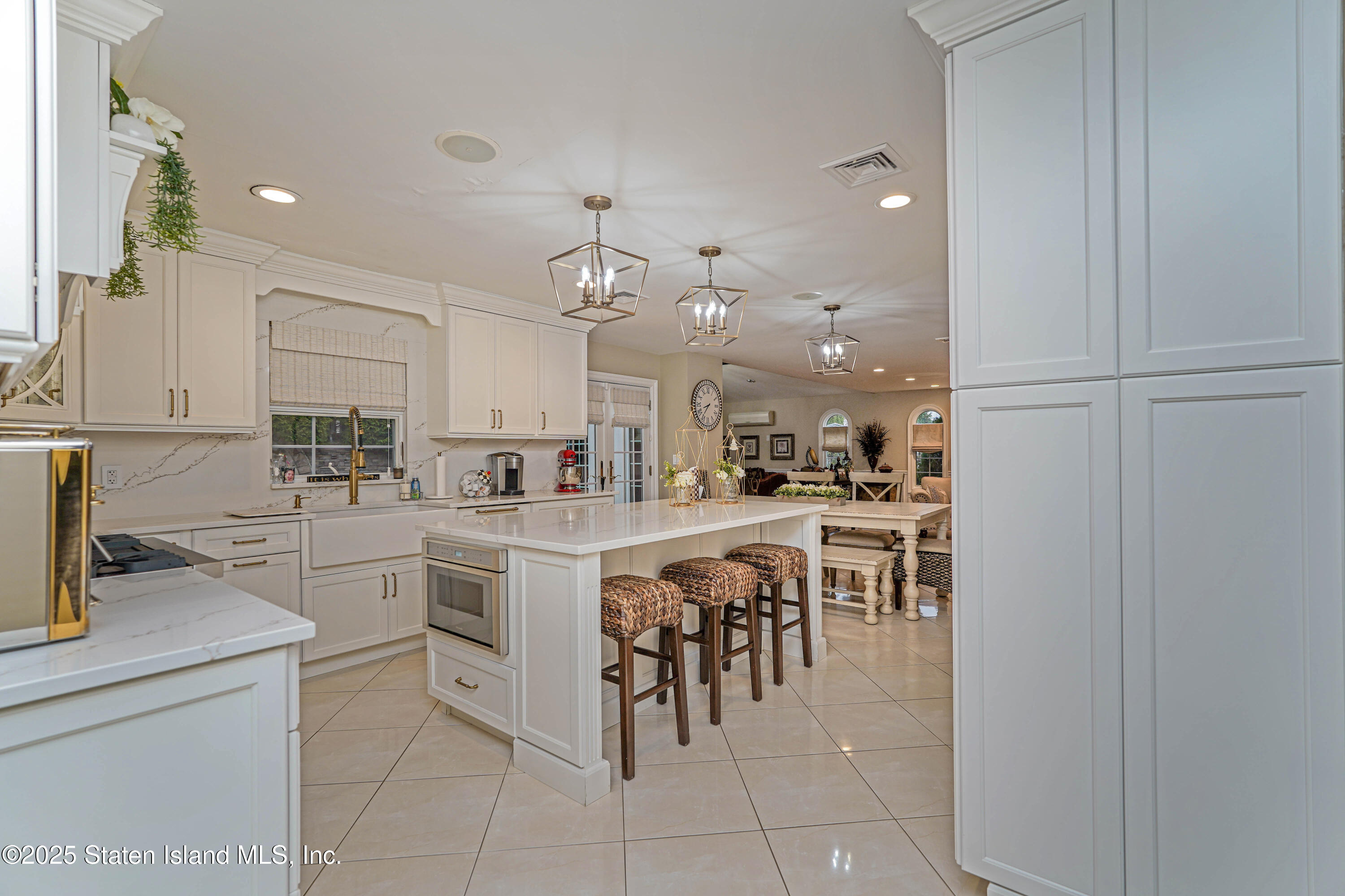 62 Ruxton Avenue Staten Island, NY 10312 - Photo 23 of 71 a kitchen with cabinets and chairs