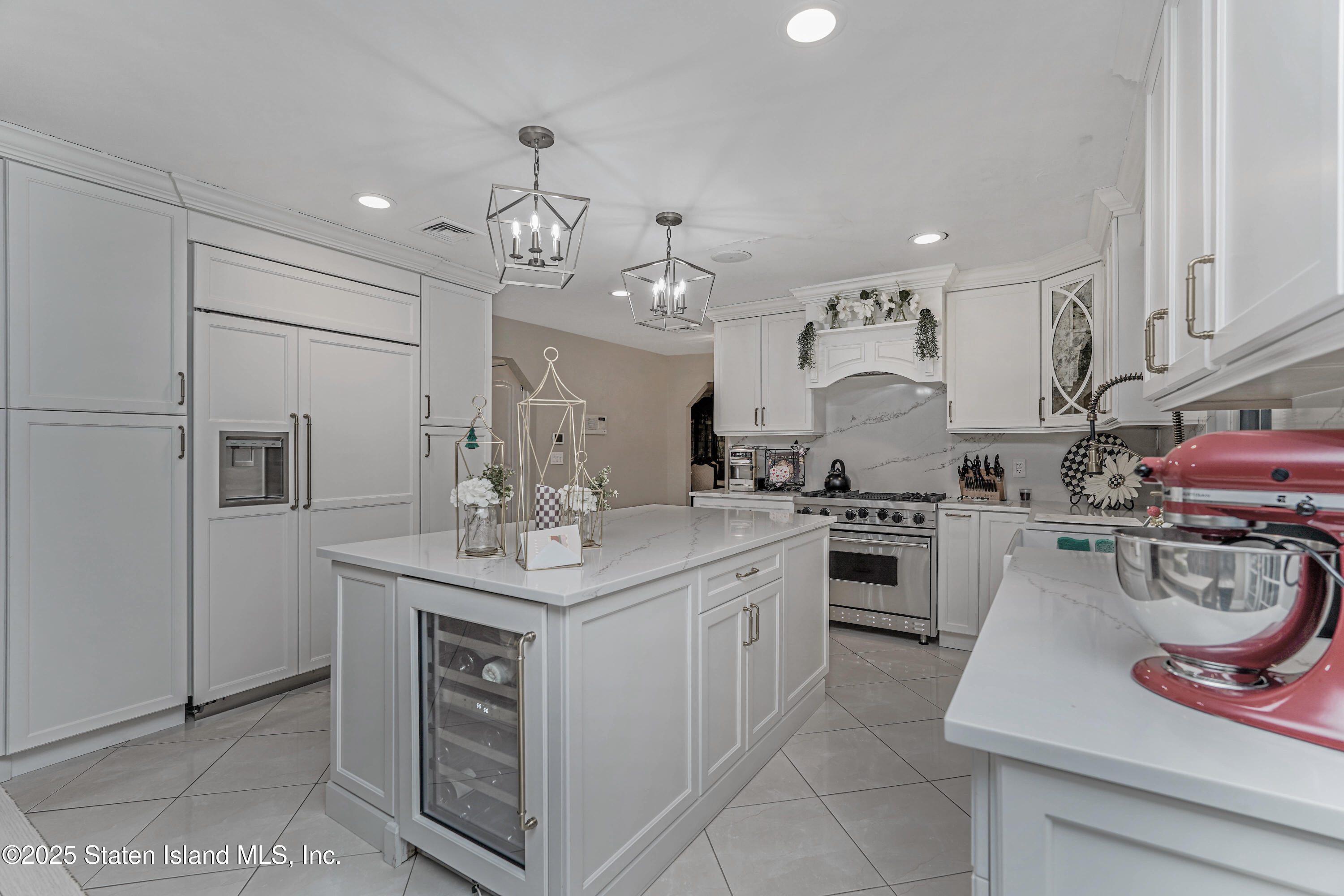 62 Ruxton Avenue Staten Island, NY 10312 - Photo 25 of 71 a kitchen with kitchen island granite countertop a sink stove and white cabinets