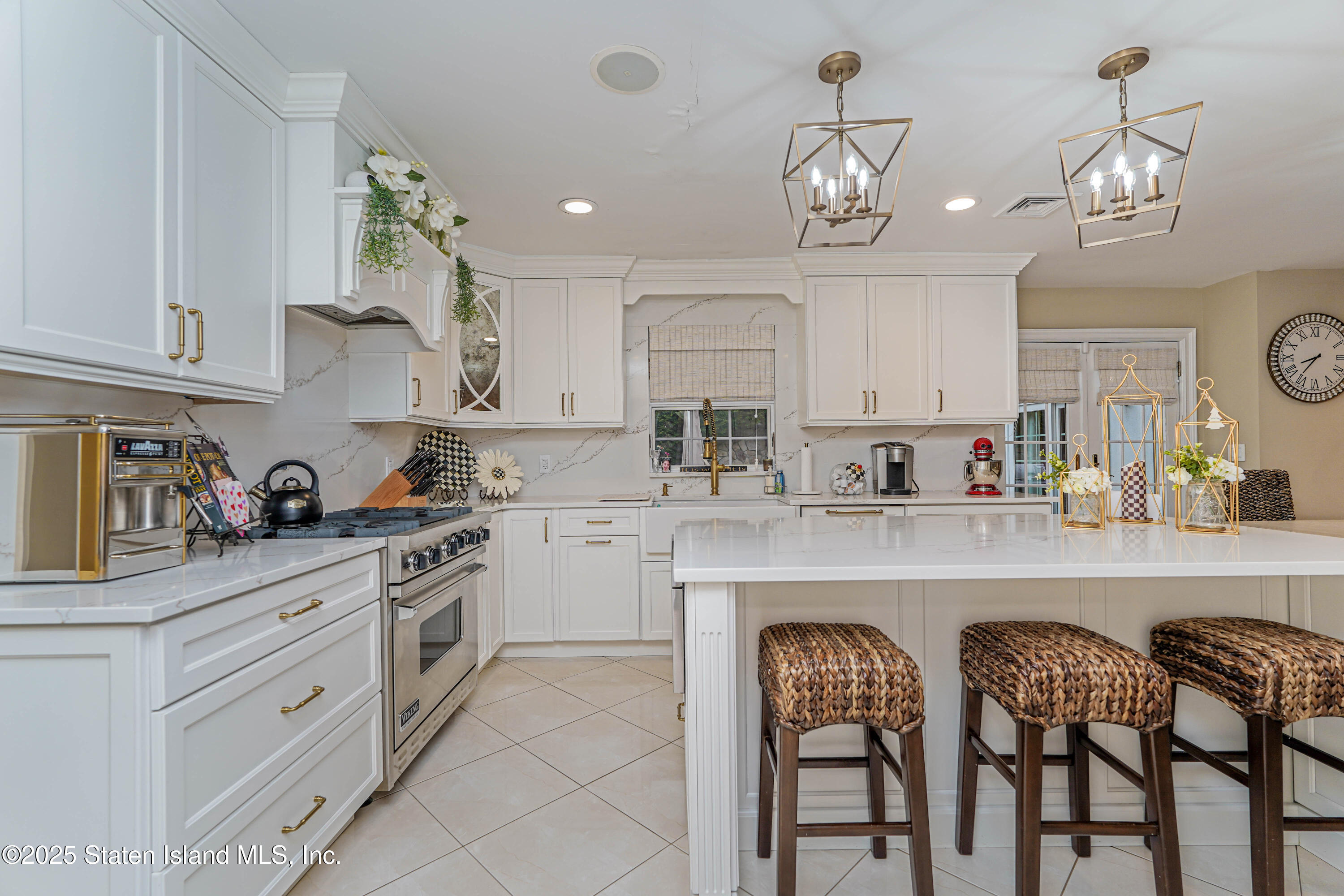 62 Ruxton Avenue Staten Island, NY 10312 - Photo 27 of 71 a kitchen with stainless steel appliances granite countertop a table chairs and white cabinets