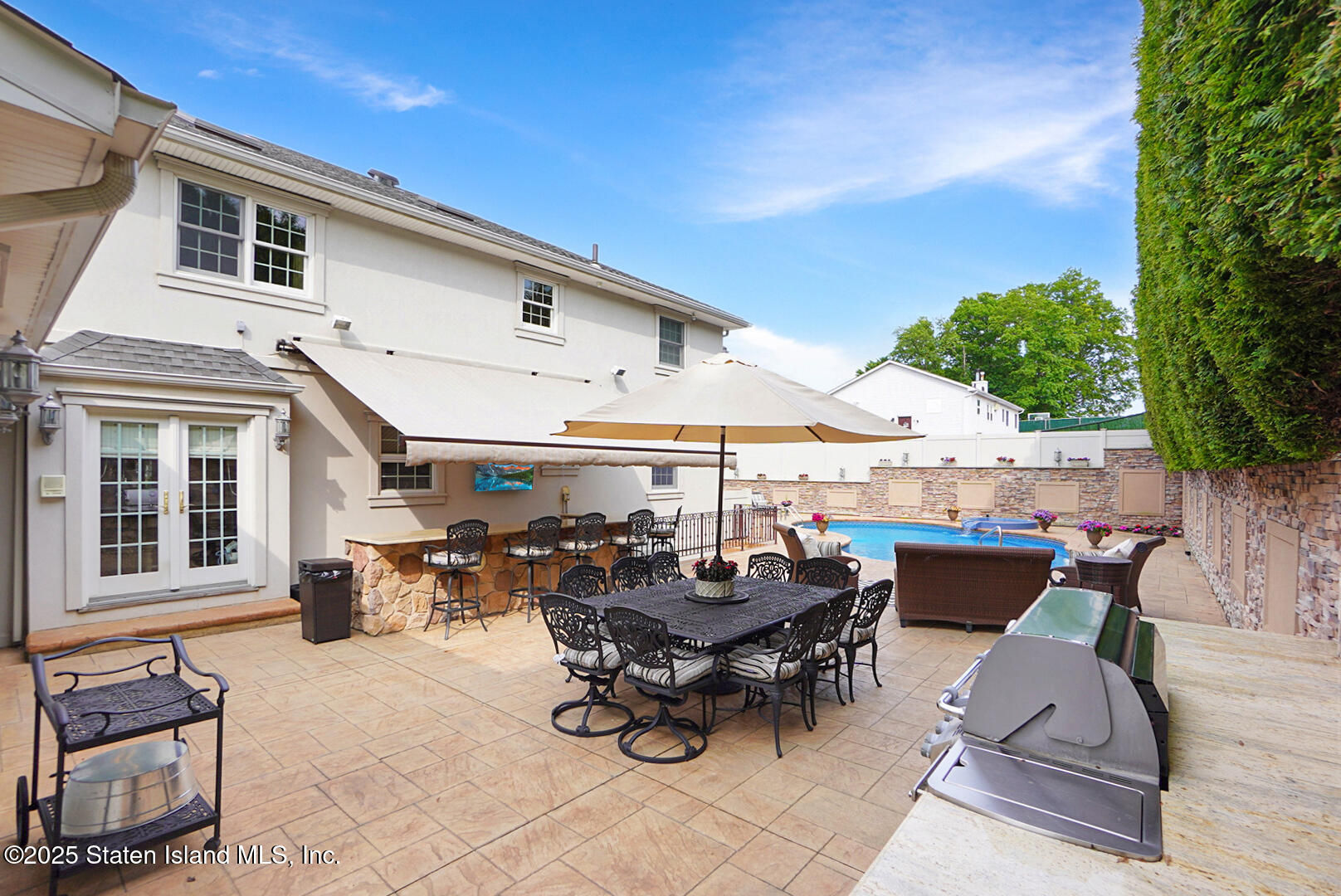 62 Ruxton Avenue Staten Island, NY 10312 - Photo 57 of 71 a view of a patio with table and chairs potted plants and a large tree