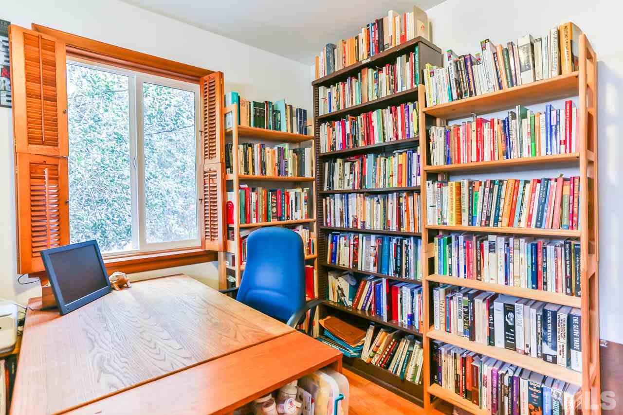 604 Beaver Dam Road Raleigh, NC 27607 - Photo 14 of 24 a bedroom with a bed and a book shelf