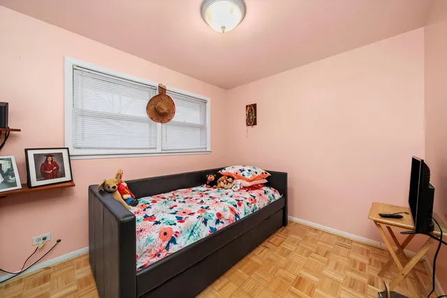 a bedroom with a bed and dresser