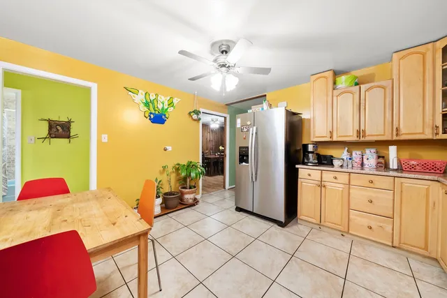 a kitchen with stainless steel appliances granite countertop a refrigerator and a stove top oven