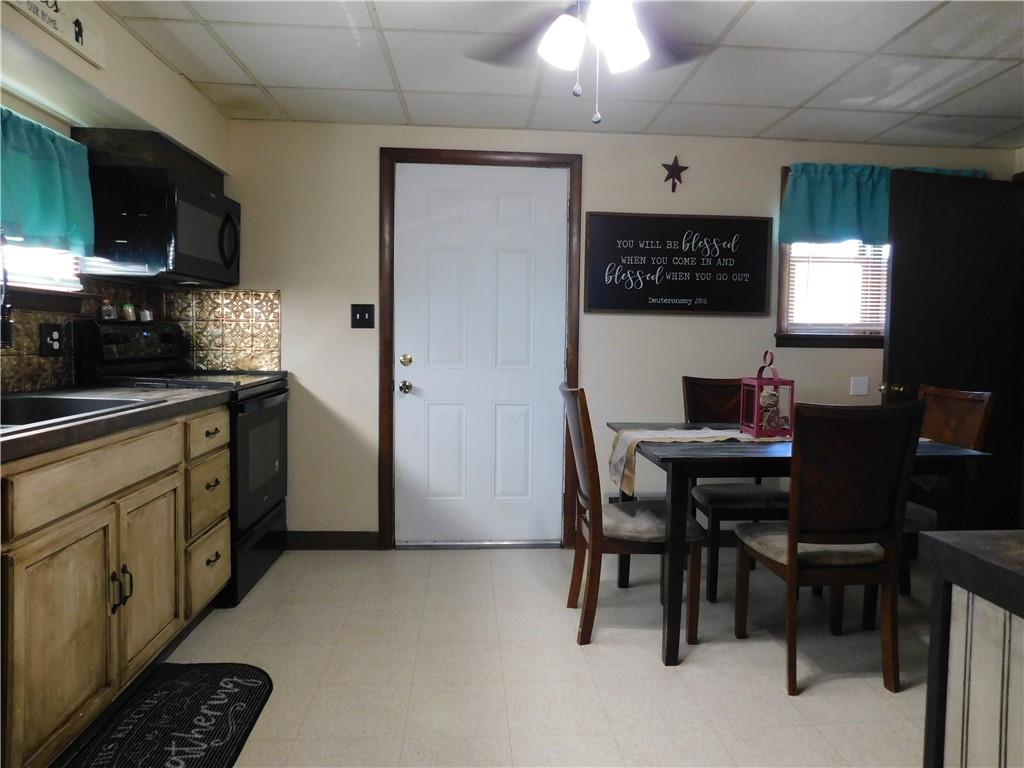 543 North Main Street Masontown, PA 15461 - Photo 6 of 32 a kitchen with a table chairs refrigerator and microwave