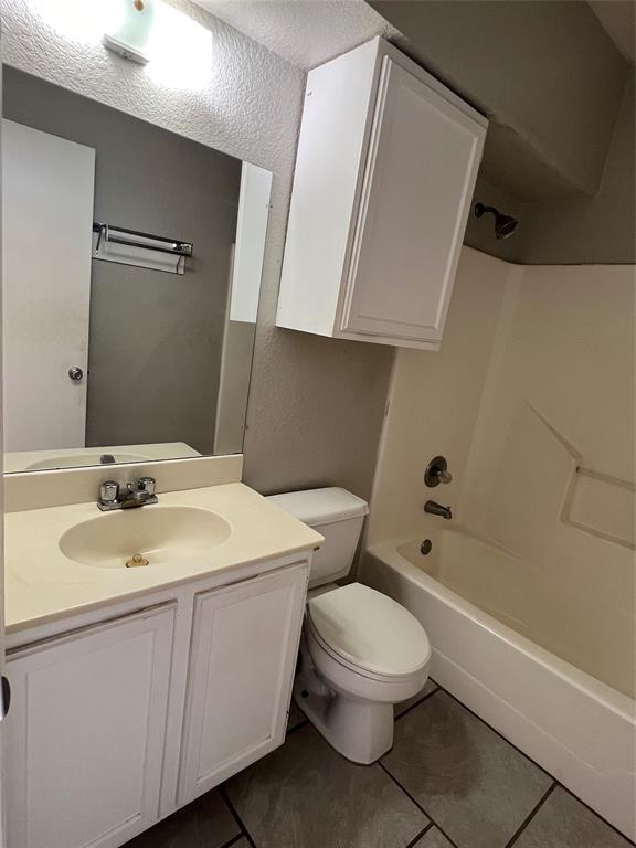 701 West Sycamore Street, Unit 303 Denton, TX 76201 - Photo 6 of 12 This bathroom has a dual show/tub combination. Notice the extra cabinet over the toilet.