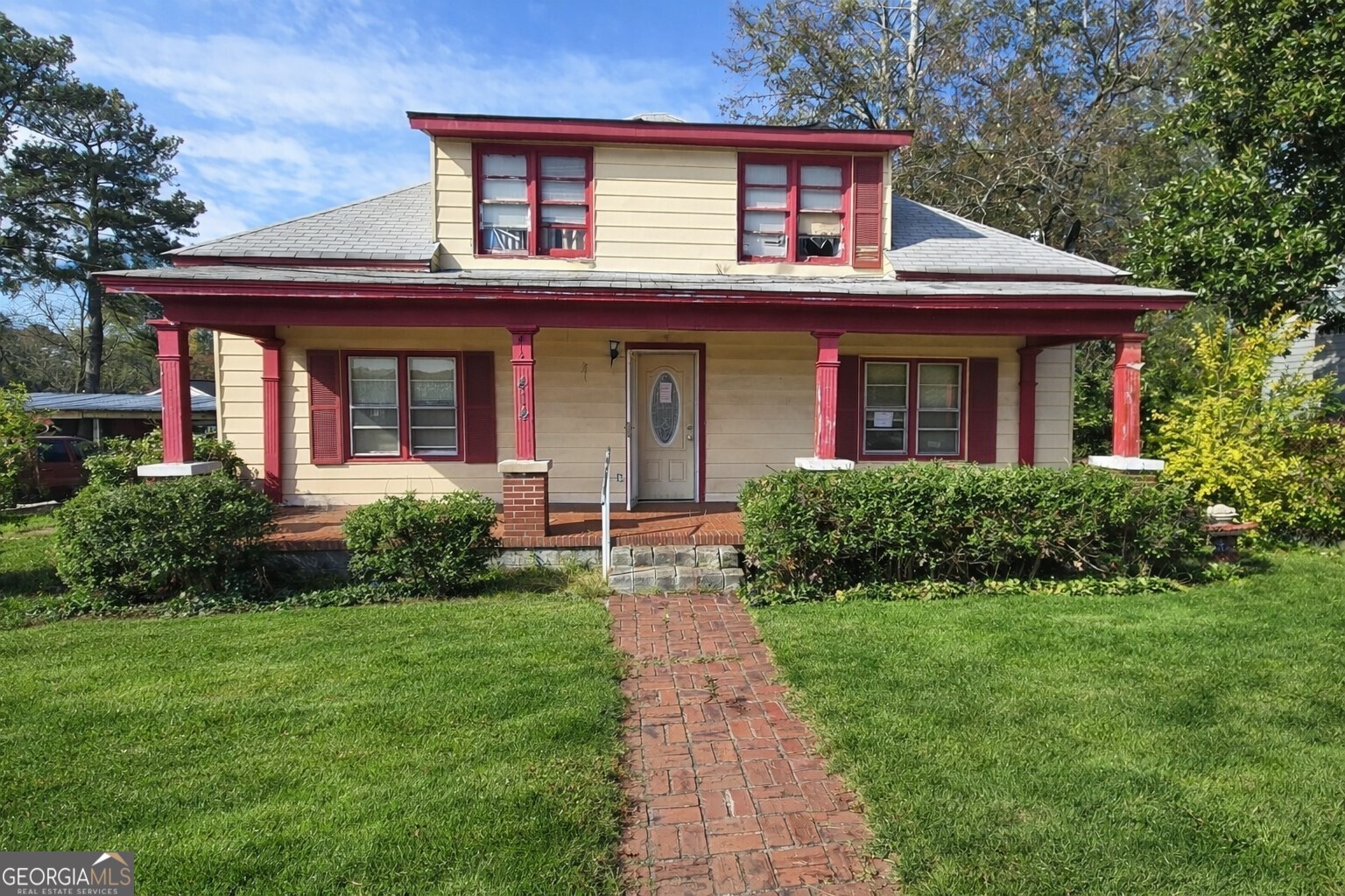 a front view of a house with garden