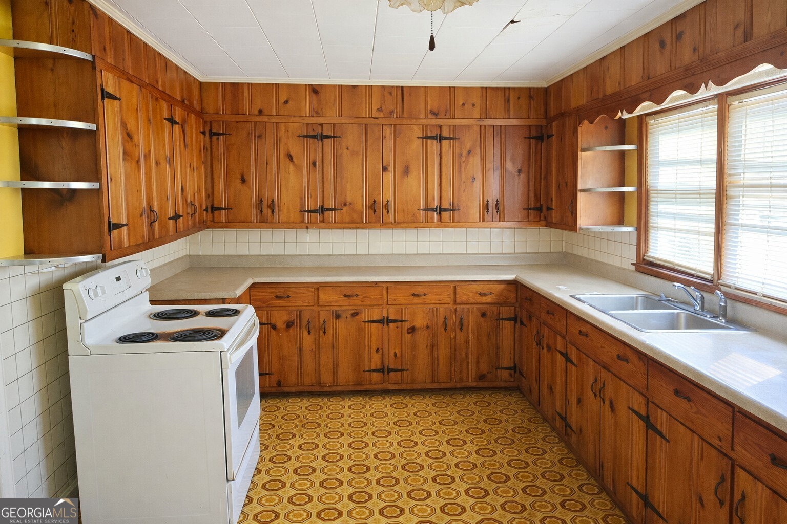 414 Wedowee Street Bowdon, GA 30108 - Photo 13 of 23 a kitchen with a sink stove and cabinets