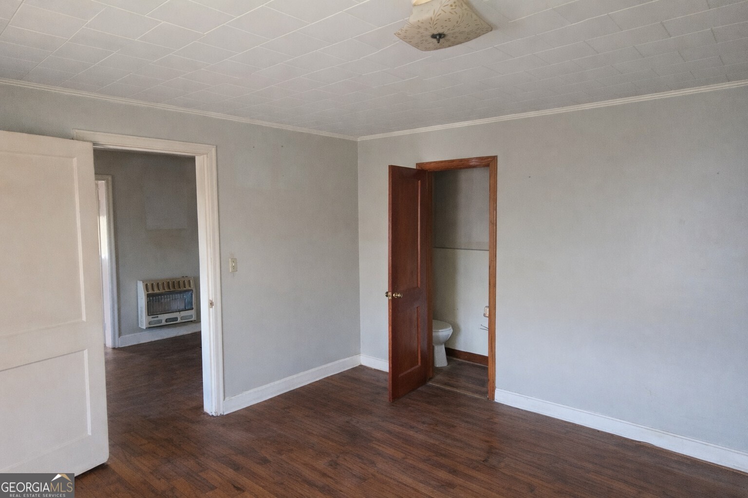 414 Wedowee Street Bowdon, GA 30108 - Photo 10 of 23 an empty room with wooden floor and closet
