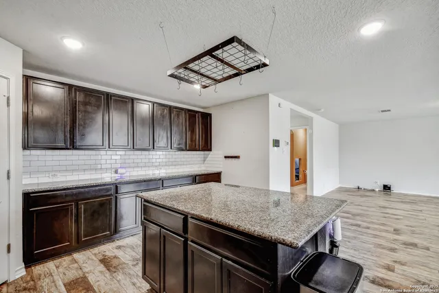 a kitchen with stainless steel appliances granite countertop a stove and a sink