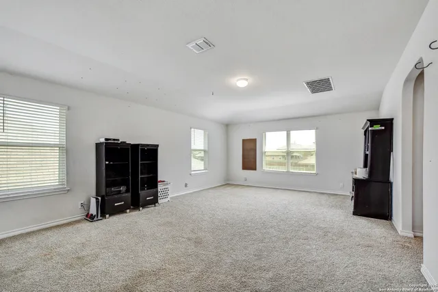 an empty room with windows and closet