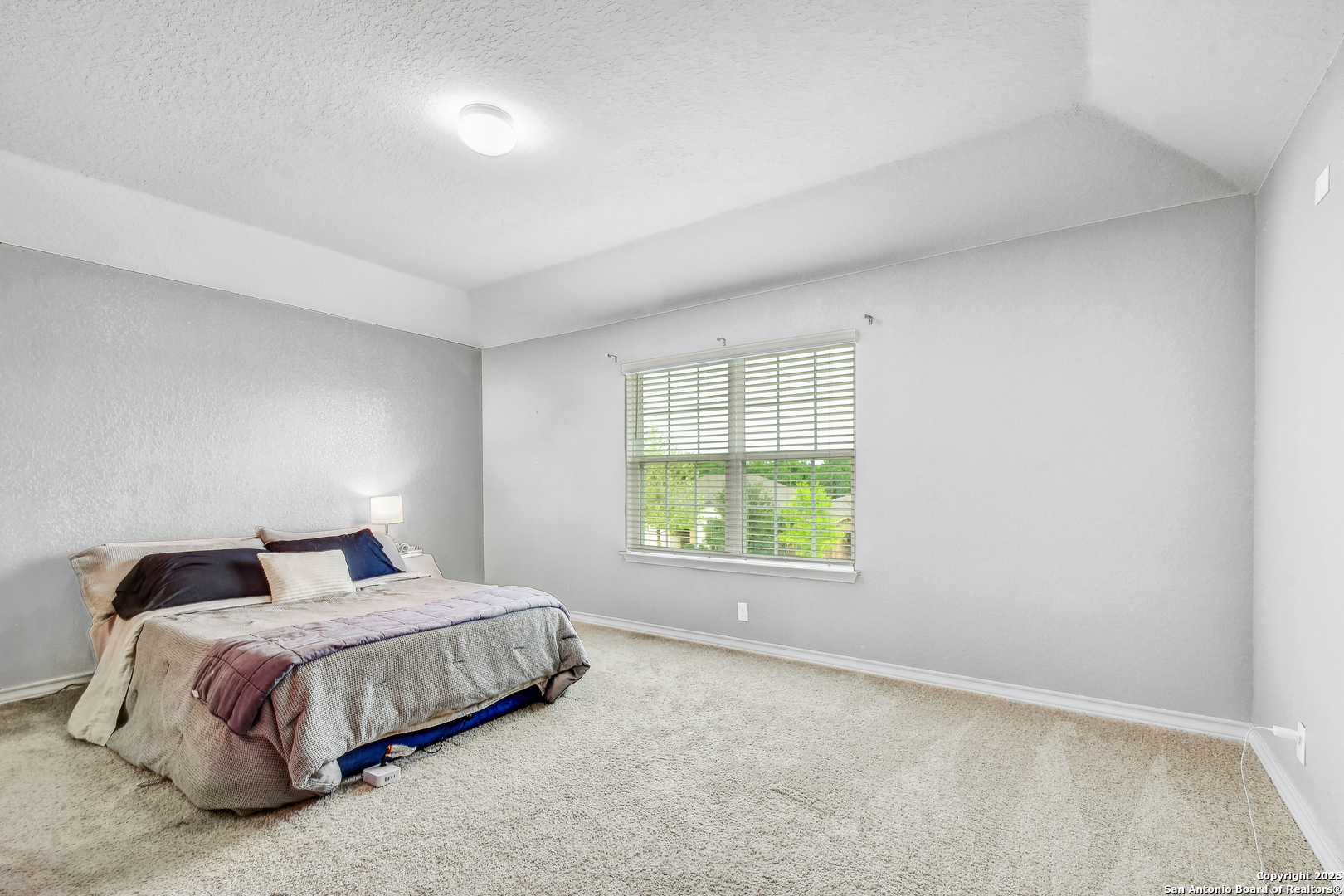9627 Baytown Coast San Antonio, TX 78254 - Photo 16 of 22 a bedroom with a bed and a window