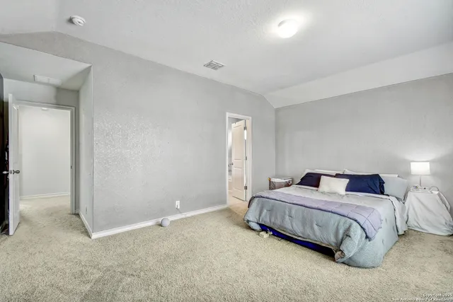 a bedroom with a bed and a night stand