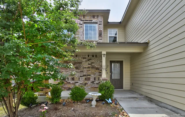 a front view of a house with plants