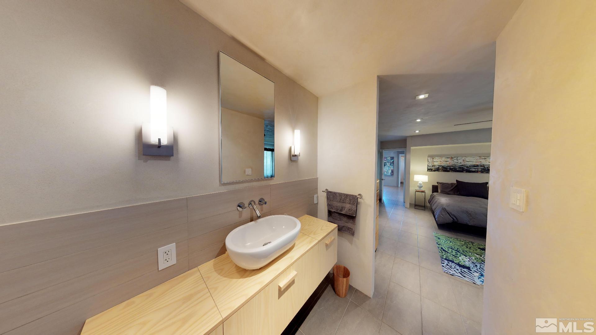 2160 Riviera Street Reno, NV 89509 - Photo 21 of 40 a en suite bathroom with a granite countertop sink and a mirror