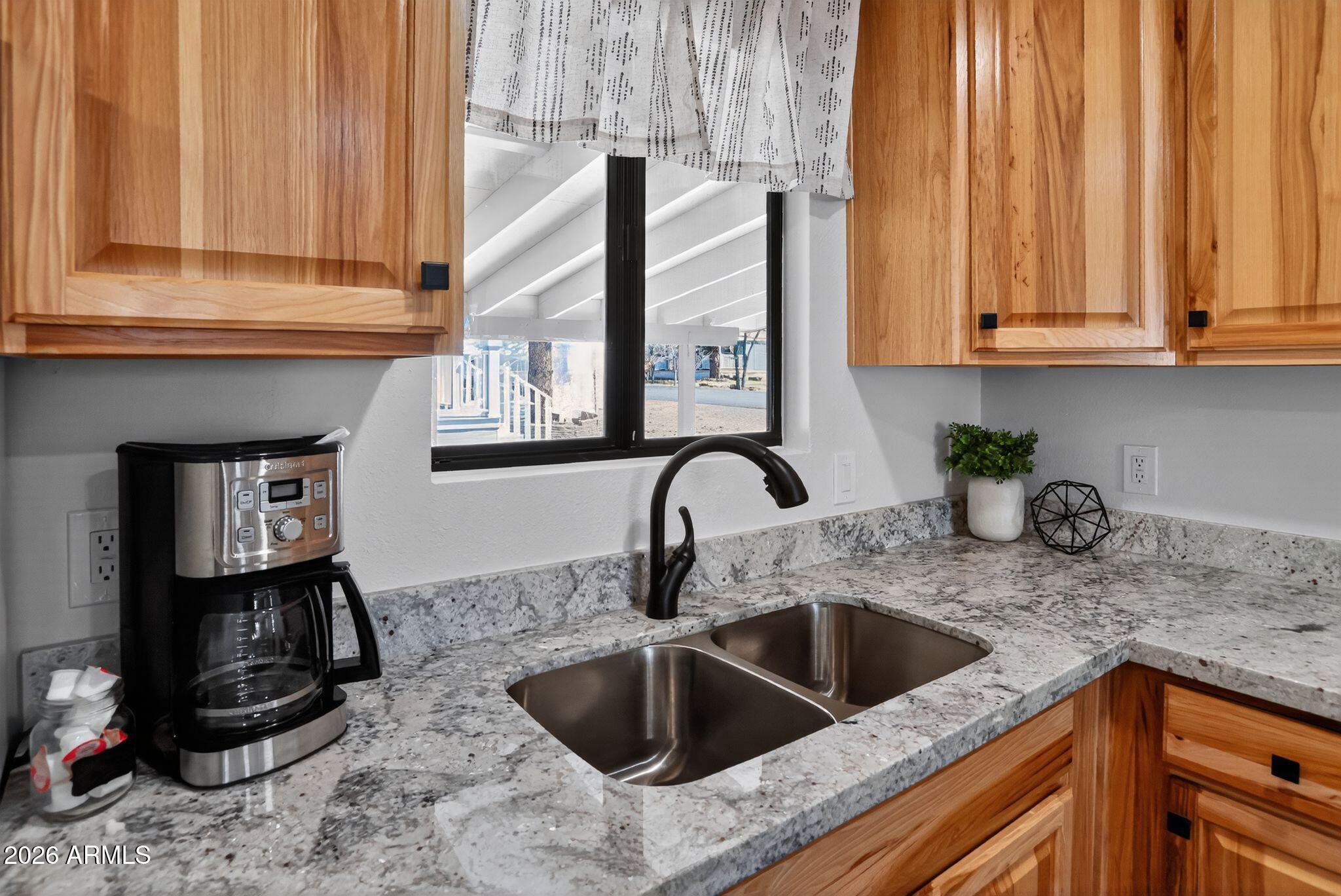 17160 Deer Run Road Munds Park, AZ 86017 - Photo 13 of 31 a kitchen with stainless steel appliances granite countertop a sink dishwasher and cabinets with wooden floor
