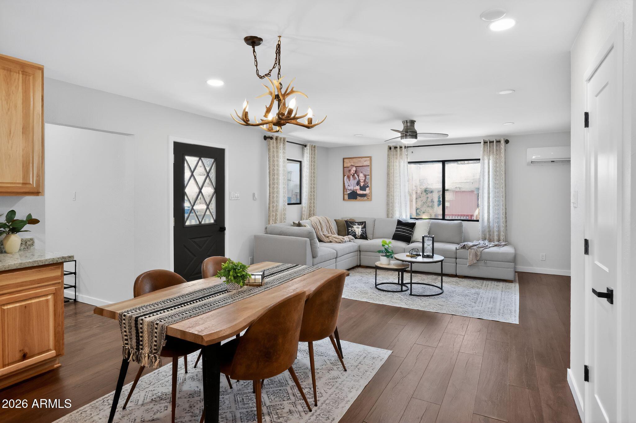 17160 Deer Run Road Munds Park, AZ 86017 - Photo 14 of 31 a living room with furniture a wooden floor and a chandelier
