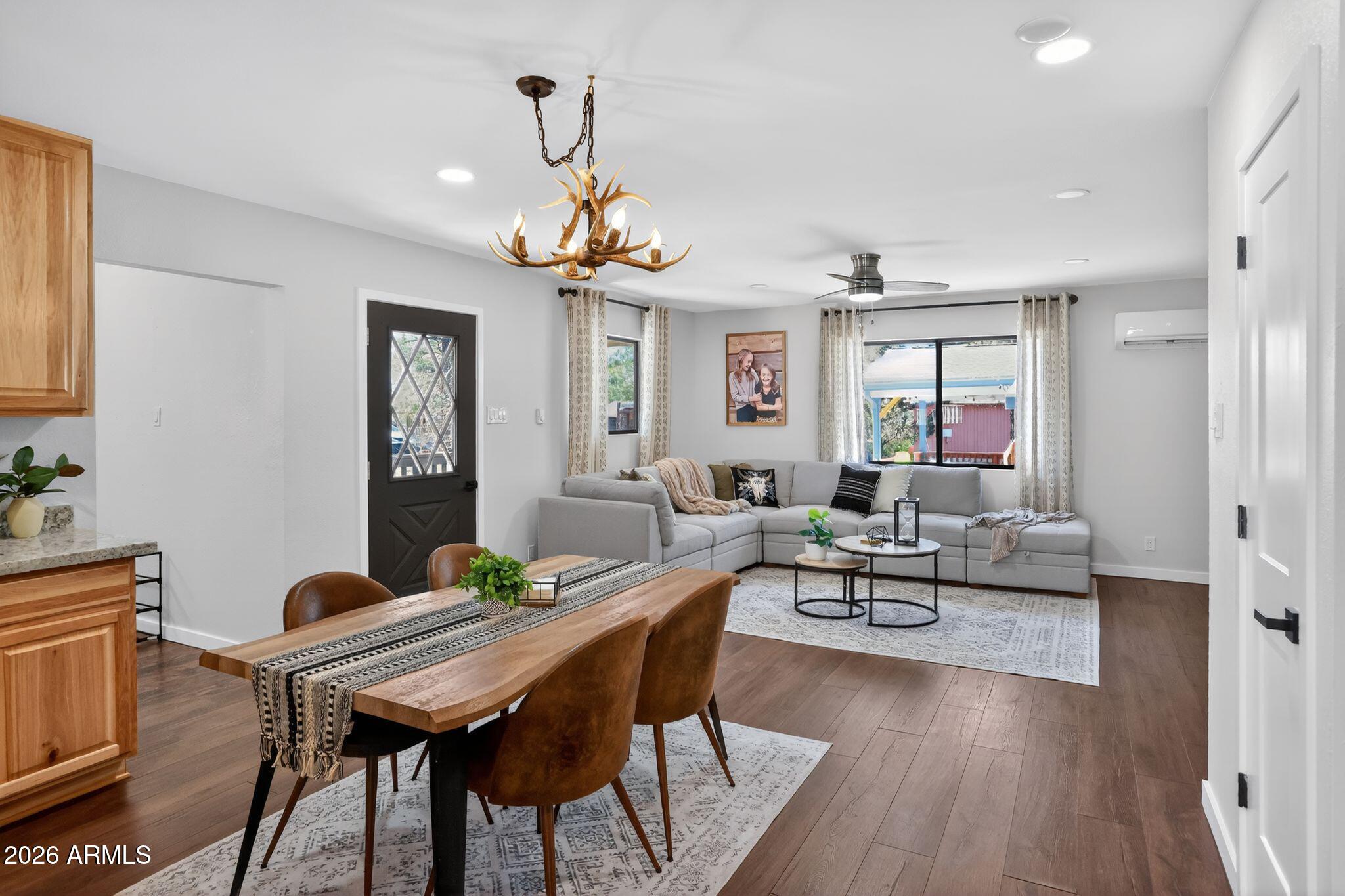17160 Deer Run Road Munds Park, AZ 86017 - Photo 15 of 31 a living room with furniture a wooden floor and a chandelier