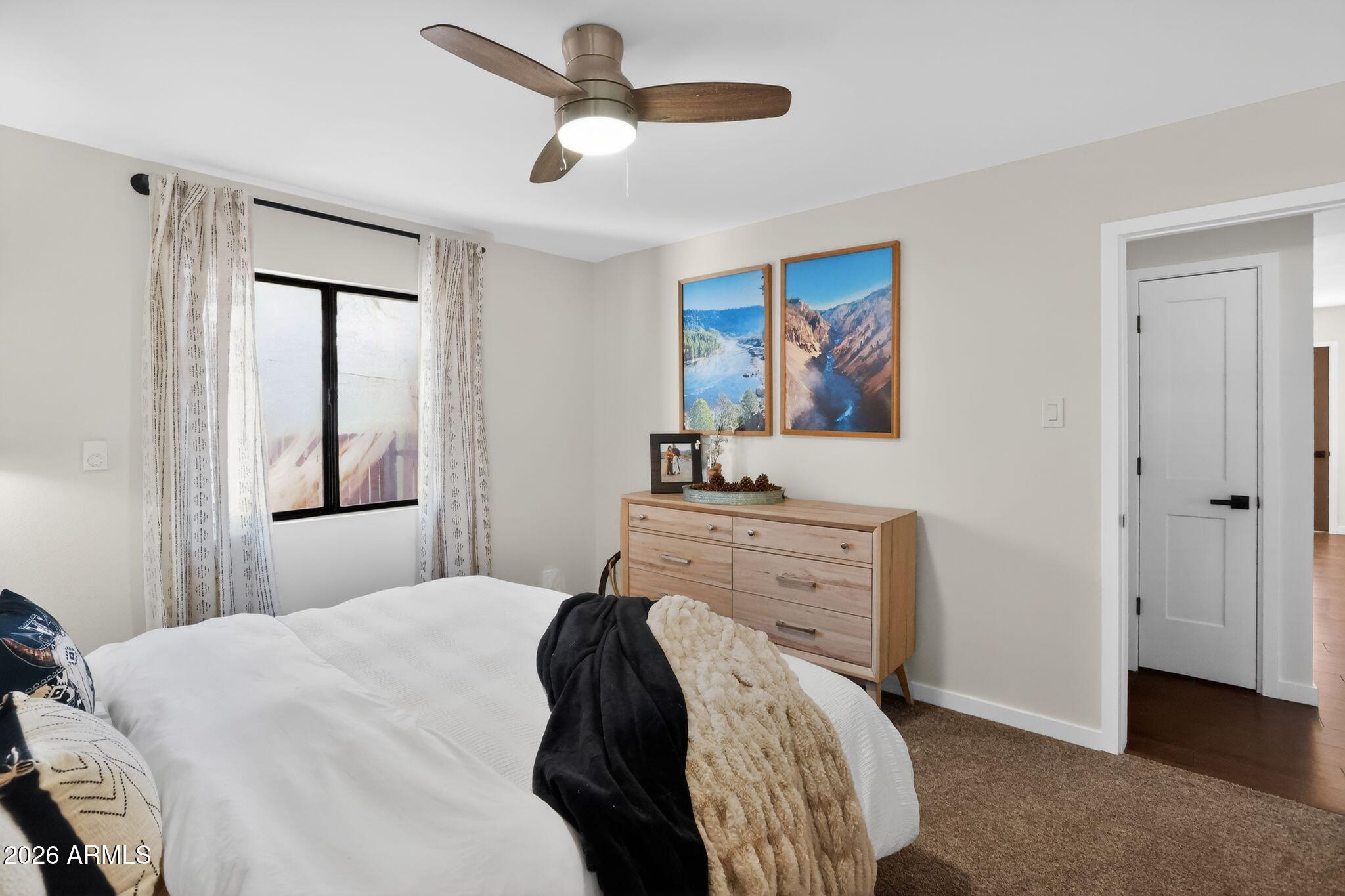 17160 Deer Run Road Munds Park, AZ 86017 - Photo 16 of 31 a bedroom with a bed and a painting on the wall