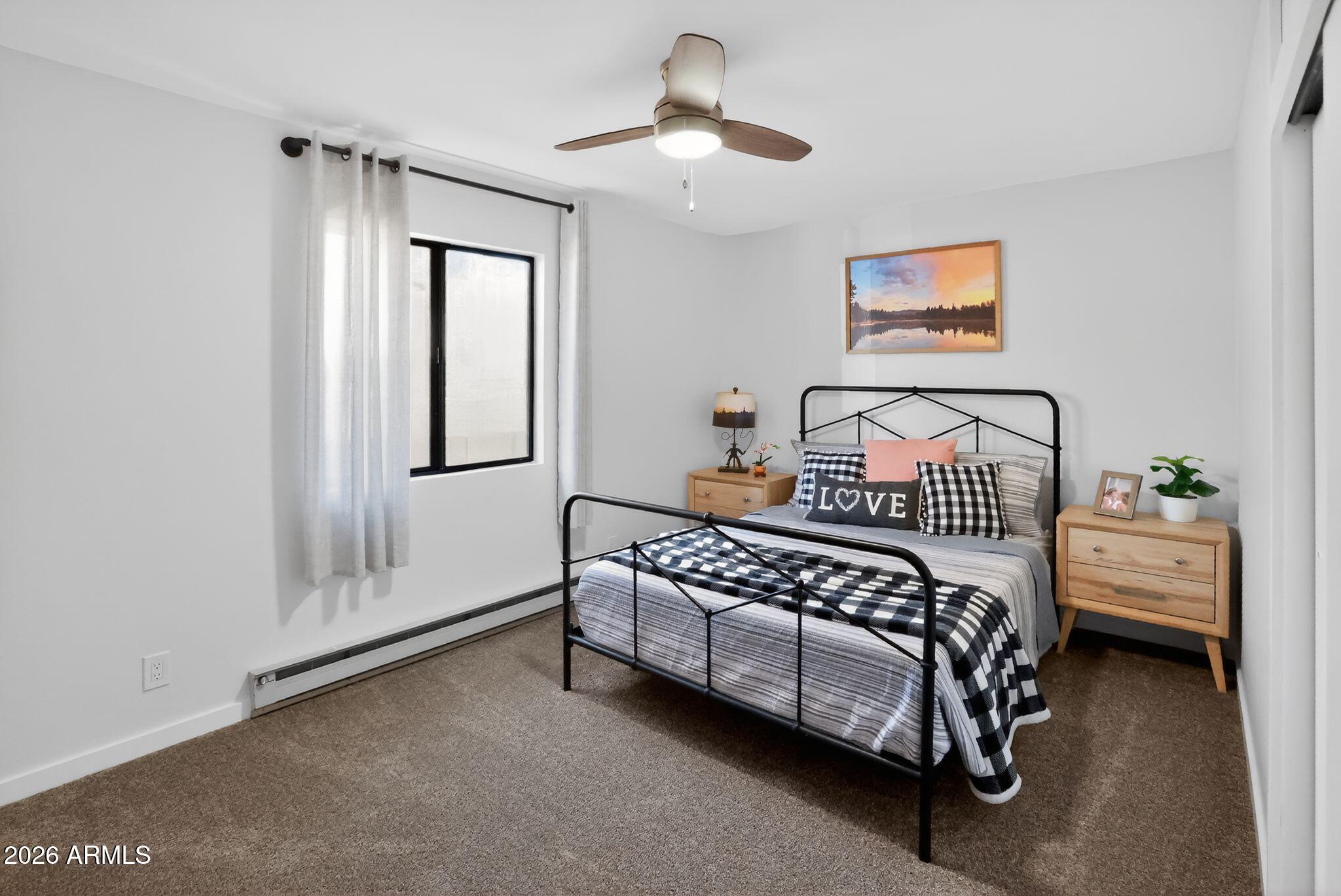 17160 Deer Run Road Munds Park, AZ 86017 - Photo 18 of 31 a bedroom with a bed and a chandelier