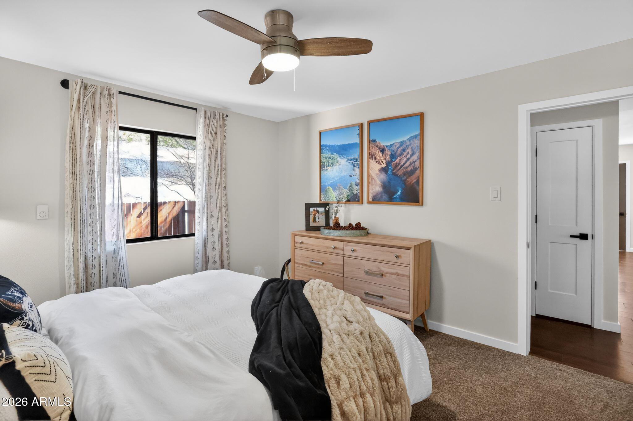 17160 Deer Run Road Munds Park, AZ 86017 - Photo 19 of 31 a bedroom with a bed and a painting on the wall