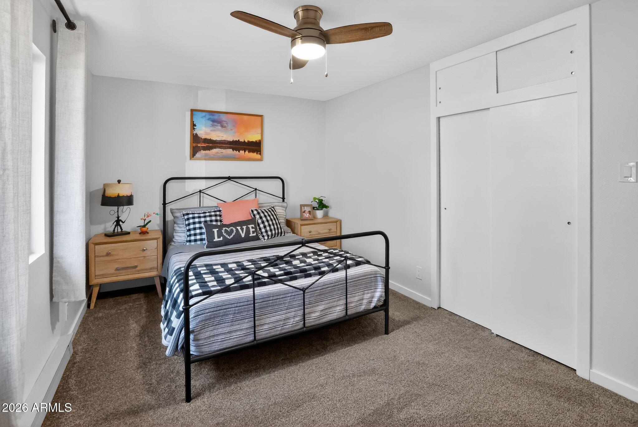 17160 Deer Run Road Munds Park, AZ 86017 - Photo 21 of 31 a bedroom with a bed and window