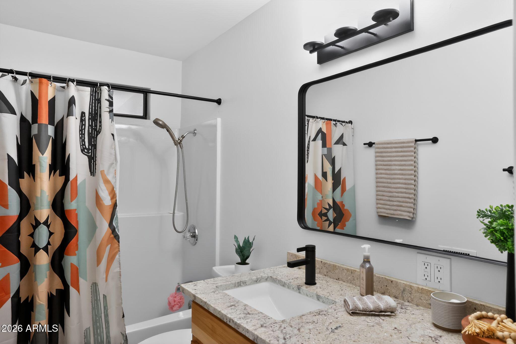 17160 Deer Run Road Munds Park, AZ 86017 - Photo 23 of 31 a bathroom with a granite countertop sink a mirror and shower