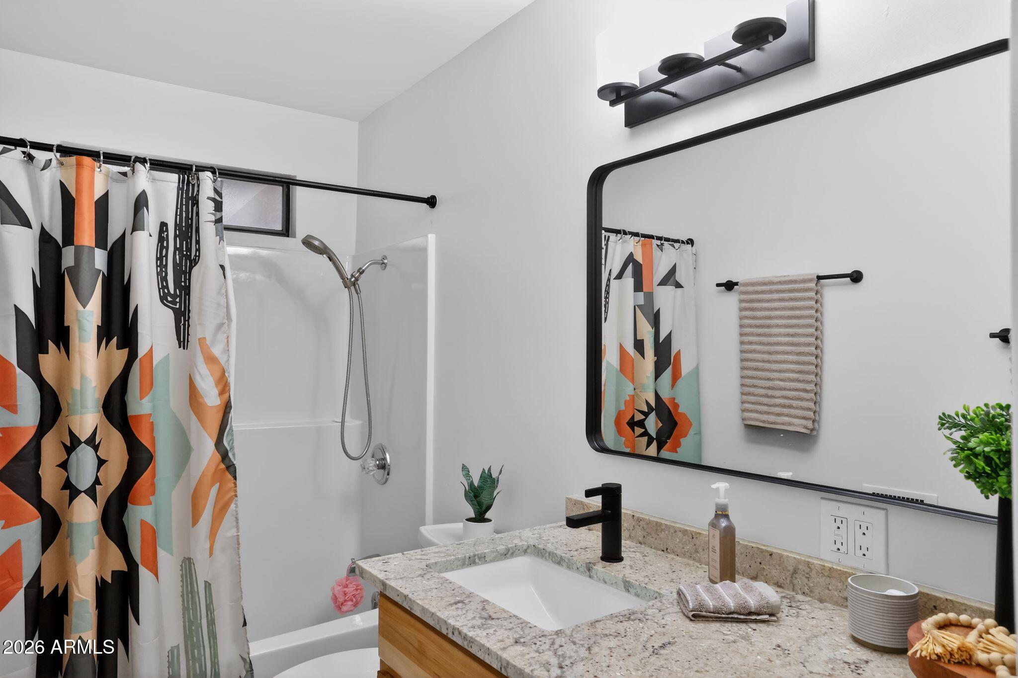 17160 Deer Run Road Munds Park, AZ 86017 - Photo 25 of 31 a bathroom with a granite countertop sink a mirror and shower