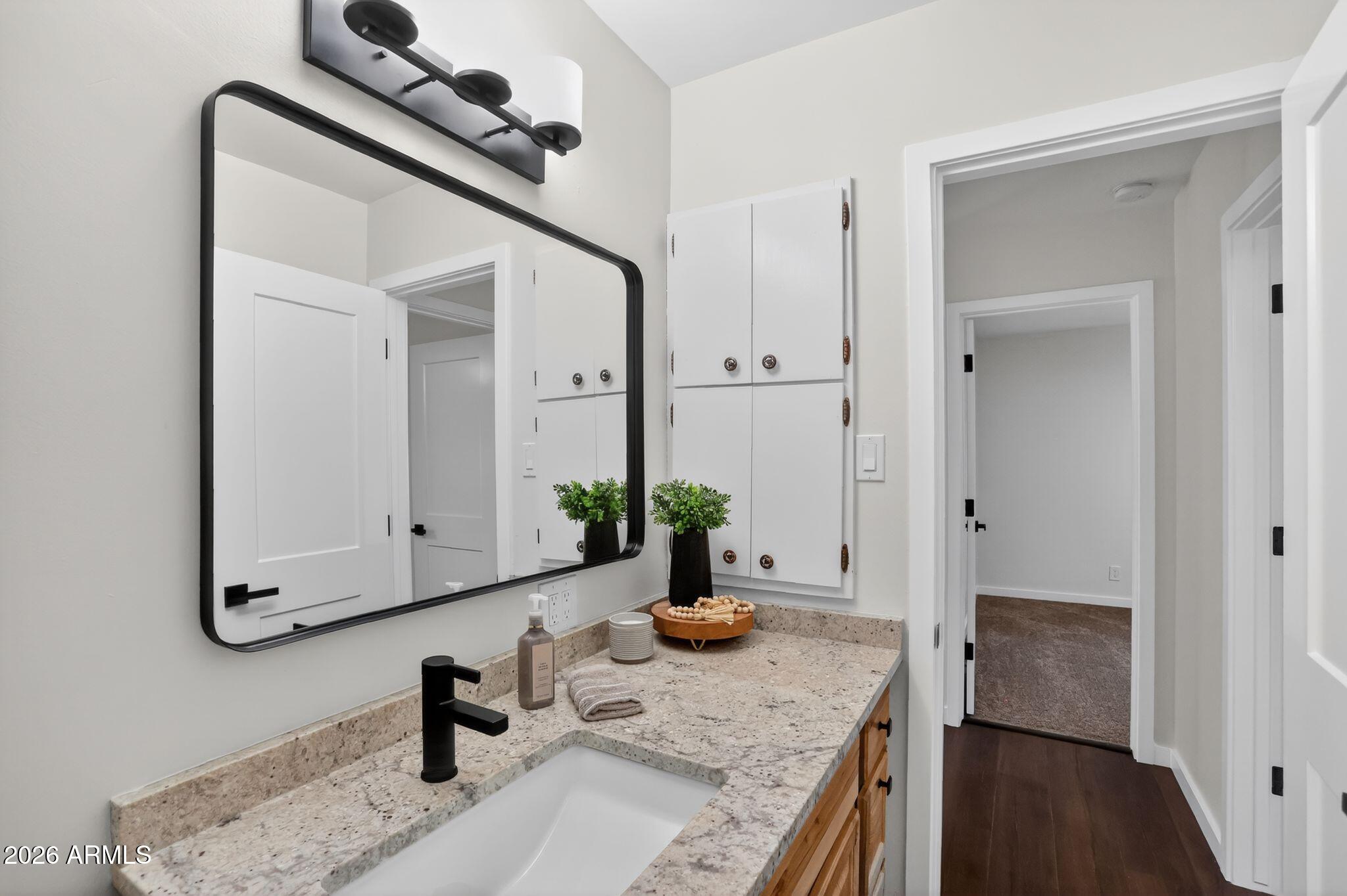 17160 Deer Run Road Munds Park, AZ 86017 - Photo 26 of 31 a bathroom with a granite countertop sink and a mirror