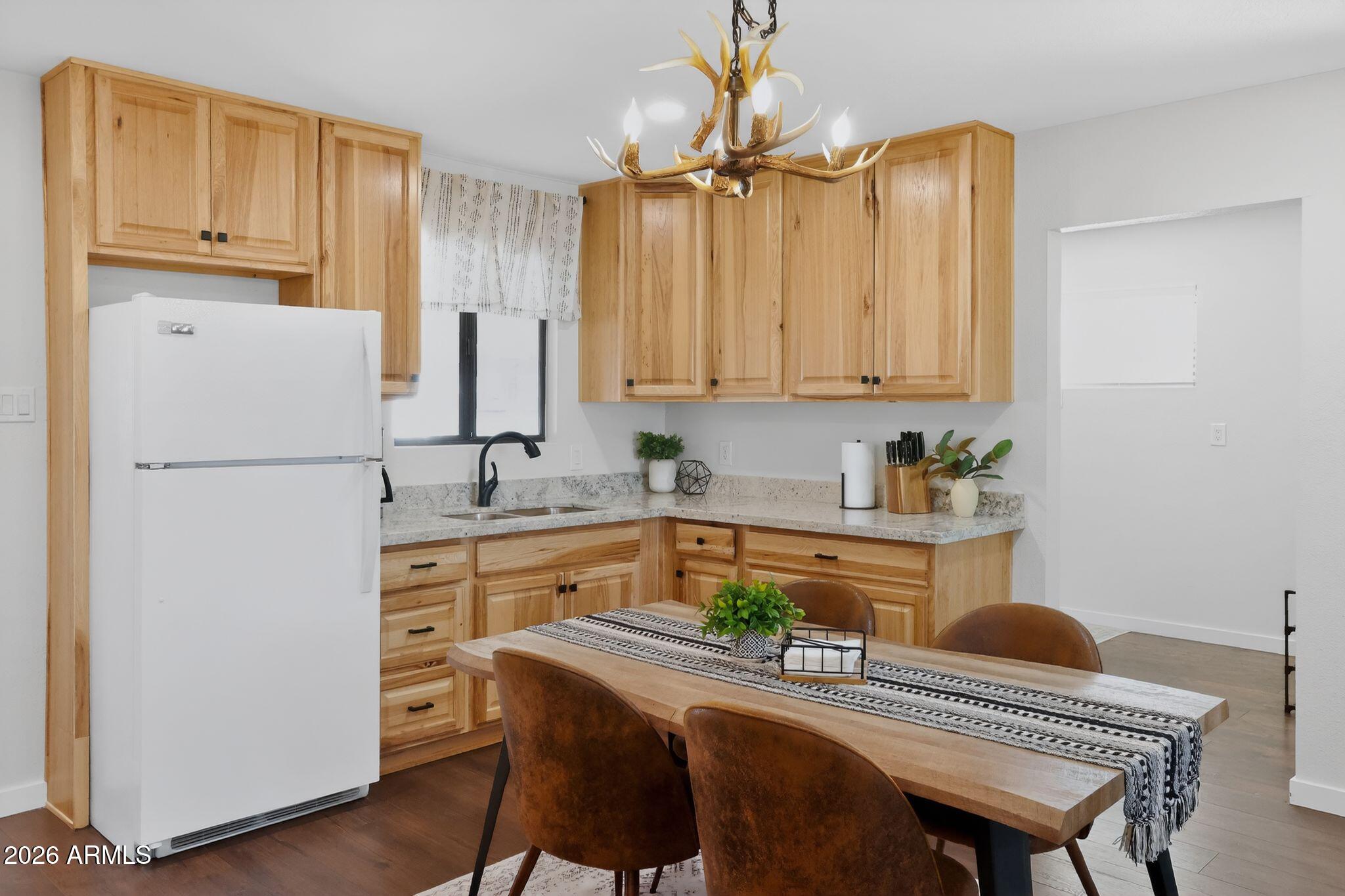17160 Deer Run Road Munds Park, AZ 86017 - Photo 8 of 31 a kitchen with refrigerator cabinets and wooden floor