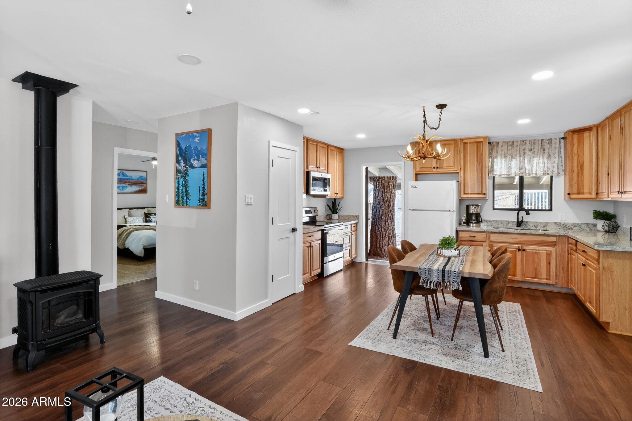 17160 Deer Run Road Munds Park, AZ 86017 - Photo 10 of 31 a view of a dining room with furniture and wooden floor