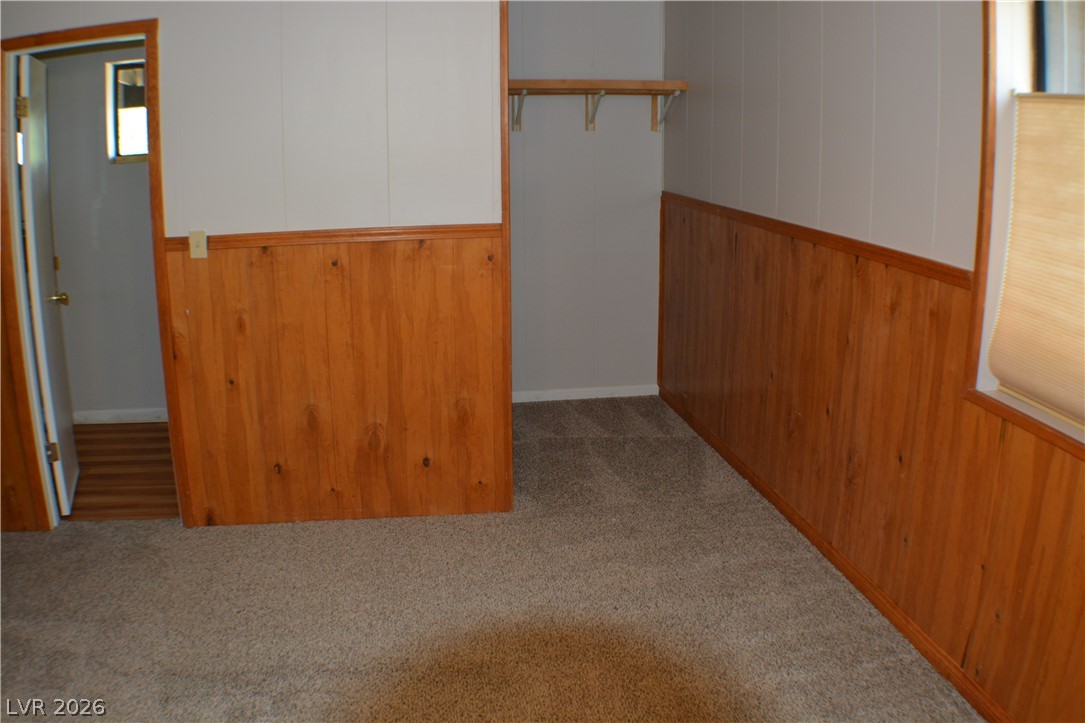 1321 Trout Canyon Road Las Vegas, NV 89124 - Photo 27 of 50 Well-lit room featuring warm wood paneling and a dedicated closet space.