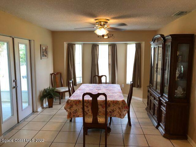 1324 Zanzibar Road Southeast Palm Bay, FL 32909 - Photo 11 of 18 a view of a dining room with furniture and chandelier