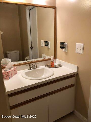 1324 Zanzibar Road Southeast Palm Bay, FL 32909 - Photo 17 of 18 a bathroom with a sink and a mirror