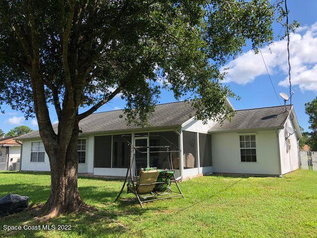 1324 Zanzibar Road Southeast Palm Bay, FL 32909 - Photo 2 of 18 a house with a garden in front of a house