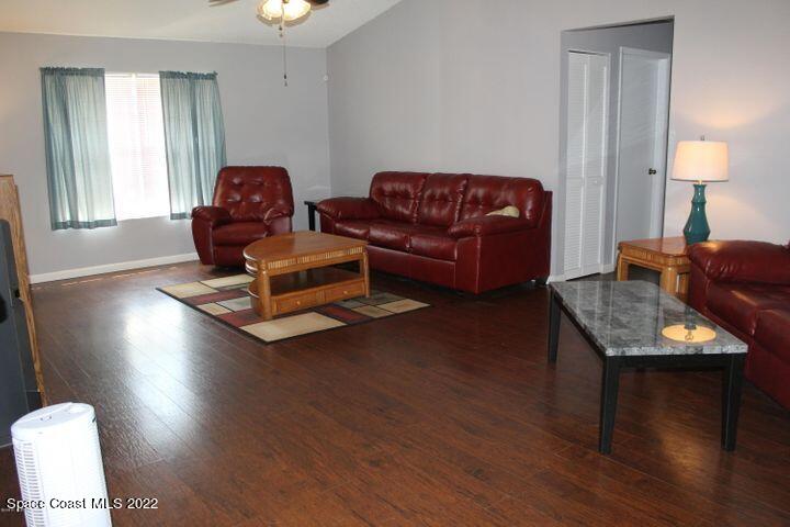 1324 Zanzibar Road Southeast Palm Bay, FL 32909 - Photo 7 of 18 a living room with furniture and a wooden floor
