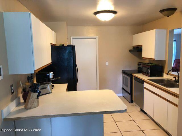1324 Zanzibar Road Southeast Palm Bay, FL 32909 - Photo 9 of 18 a kitchen with a sink cabinets and appliances