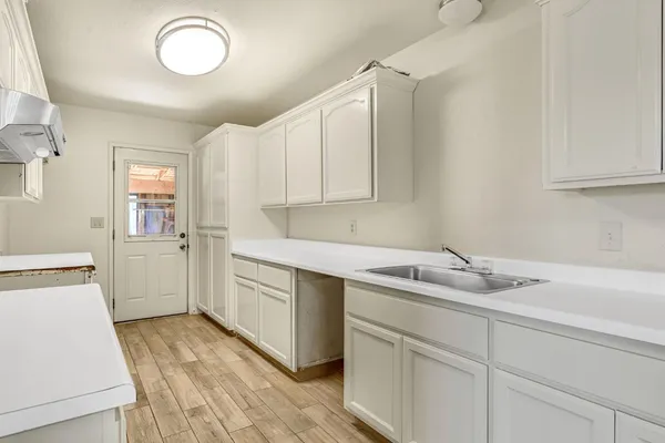 a kitchen with a sink stove and cabinets