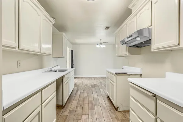 a kitchen with a sink and wooden cabinets