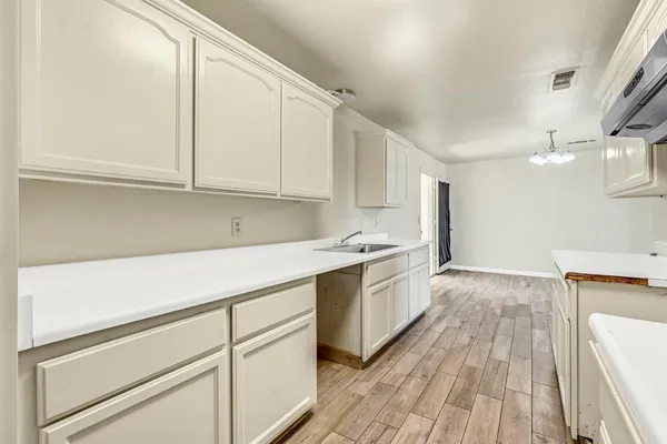 a kitchen with granite countertop white cabinets and white appliances