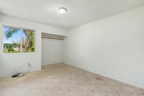 an empty room with painting on the wall