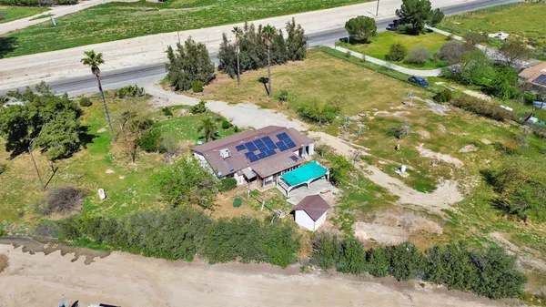 an aerial view of a house with a yard