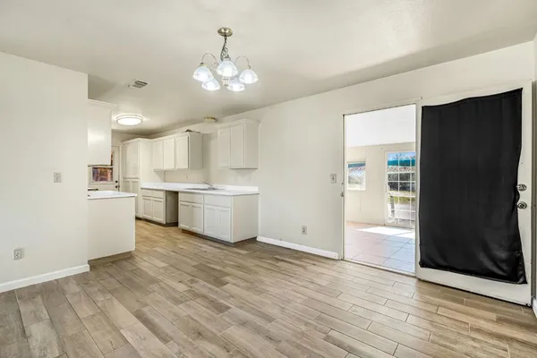 a view of kitchen with granite countertop cabinets and refrigerator
