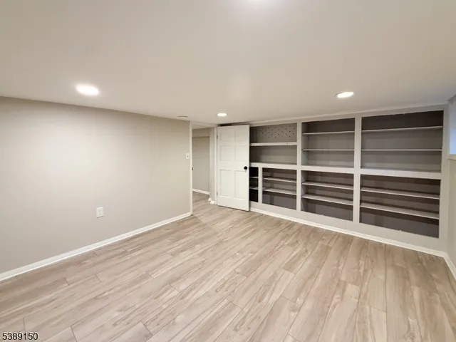 a view of an empty room with a closet and a window
